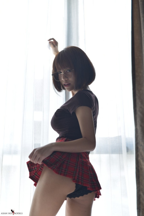 Stunning attractive oriental young flaunts her hot booty wearing a miniskirt and panties