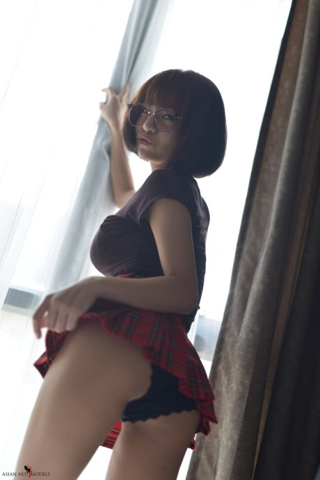 Stunning attractive oriental young flaunts her hot booty wearing a miniskirt and panties