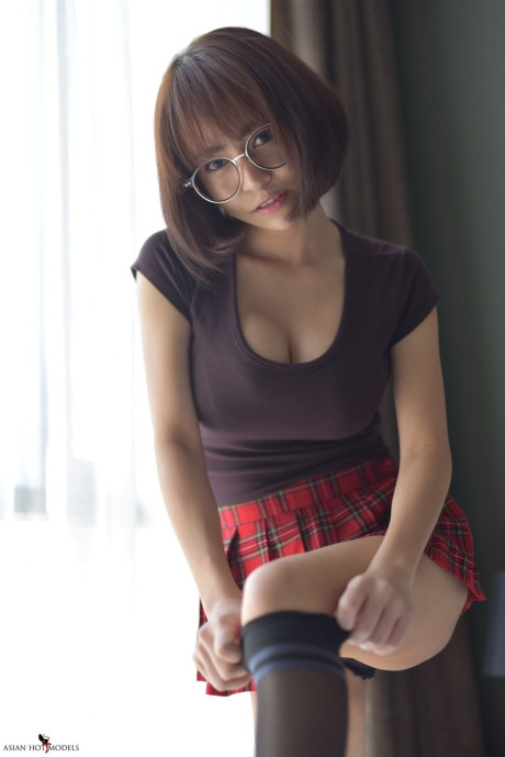 Stunning attractive oriental young flaunts her hot booty wearing a miniskirt and panties