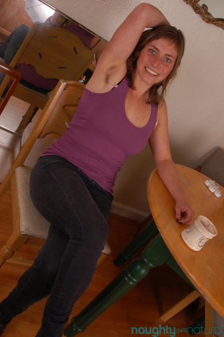 Slutty amateur Tanya unveils her bushy armpits and snatch in a solo striptease