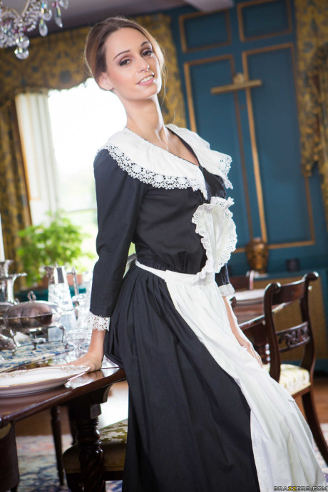 Enticing maid Erica Fontes does a striptease and shows off her round melons