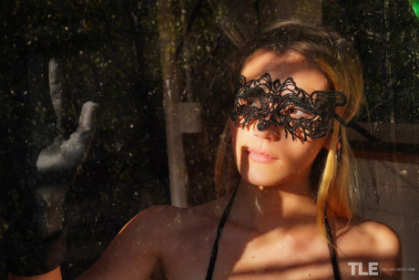 Sweet young Stefany takes off a masquerade mask in a revealing bodystocking