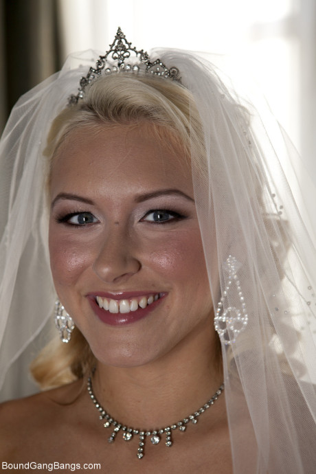 Blondy bride Katie Summers doffs her wedding dress & poses topless in undergarment