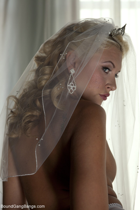 Blondy bride Katie Summers doffs her wedding dress & poses topless in undergarment