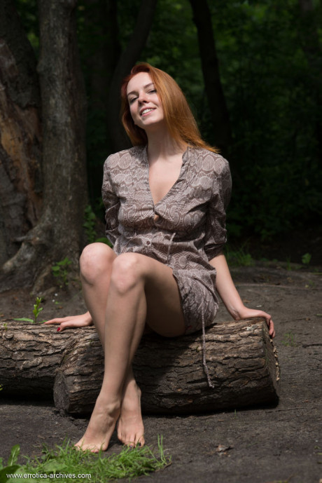 Redheaded teen Candy Red gets totally naked while at a body of water