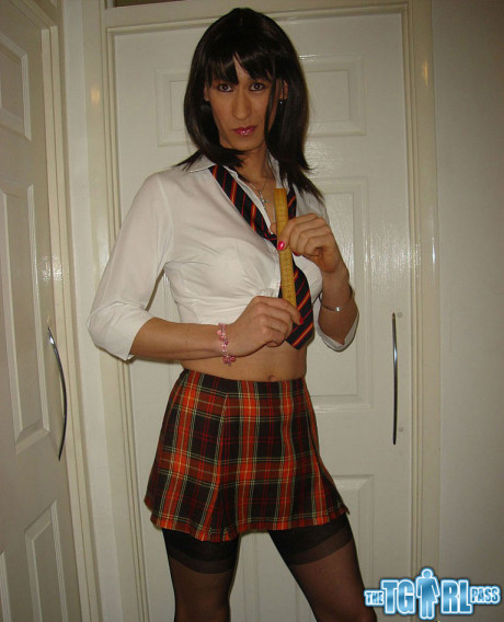 Tgirl wearing a horny tartan skirt shoots her load over a juicy behind
