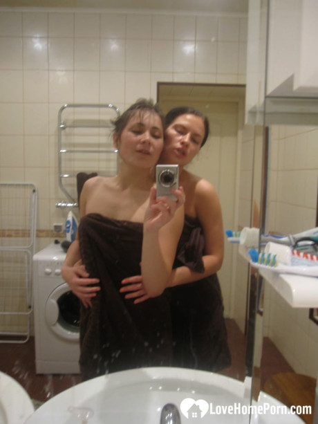 Hot amateur lesbians strip and make out while taking selfies in the bathroom