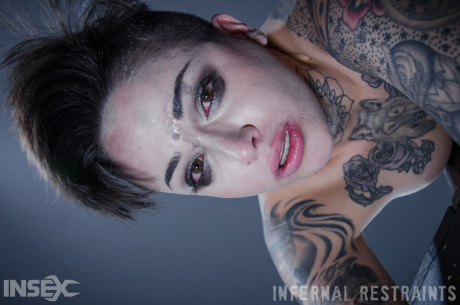 Tattooed female Leigh Raven has her moth forced open during BDSM play
