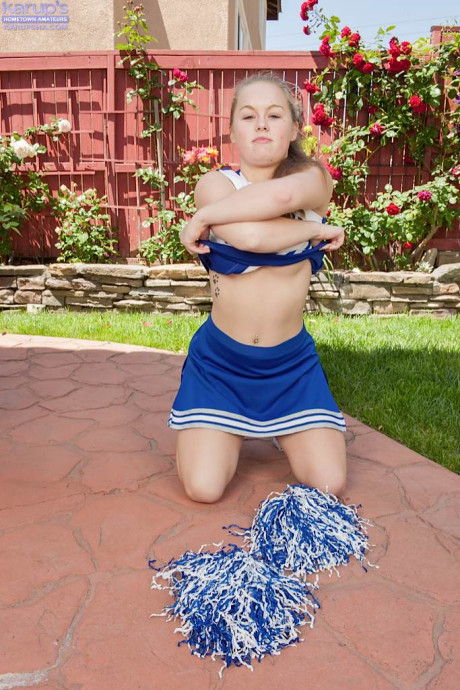 Teen cheerleader Madison Chandler spreads her pink cunt wide open on walkway
