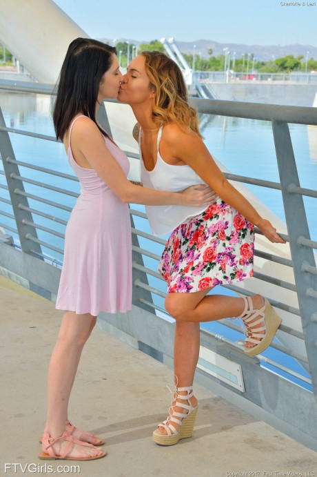 Hot lesbian babes Charlotte & Lexi kiss & exposes their monstrous boobies in public