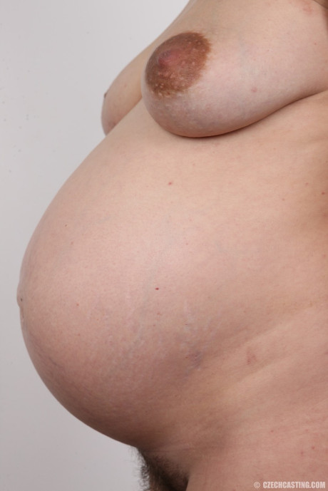 Glasses clad Andela strips to show off her sweet pregnant body nude