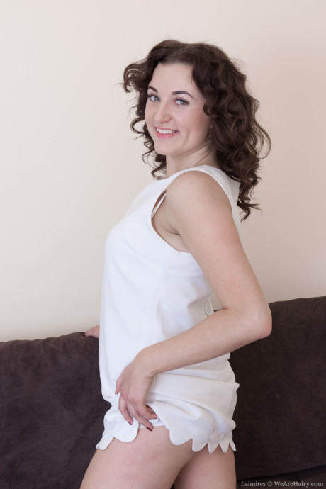 Sweet amateur Laimites reveals her bushy crotch and small breasts on a couch