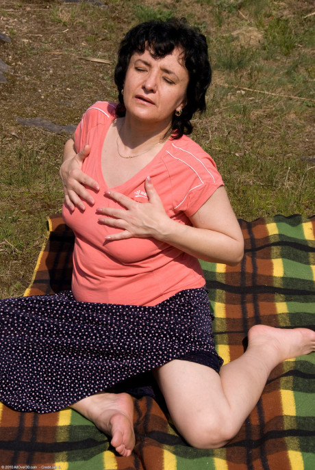 Naughty older old lady Sandra K shows her melons and toys her bushy beaver outdoors