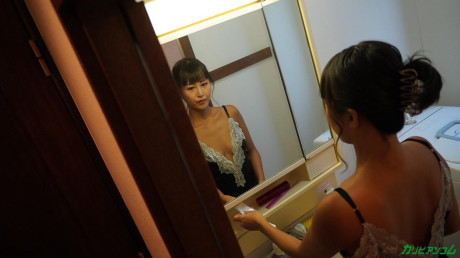 Pretty oriental MILF Miki Hoshino gets stripped and sits on a white bed