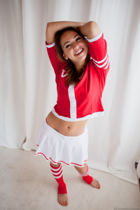 Sweet brunette cheerleader flashing young young boobs and behind in sports socks