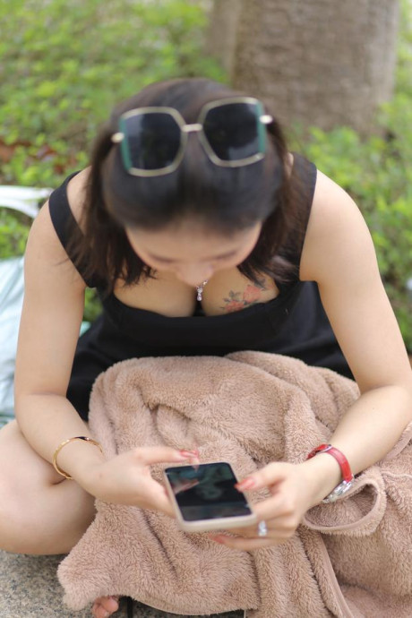 Chinese beauty Julia Nhatle posing in her little black dress & heels outdoors