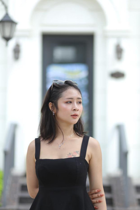 Chinese beauty Julia Nhatle posing in her little black dress & heels outdoors