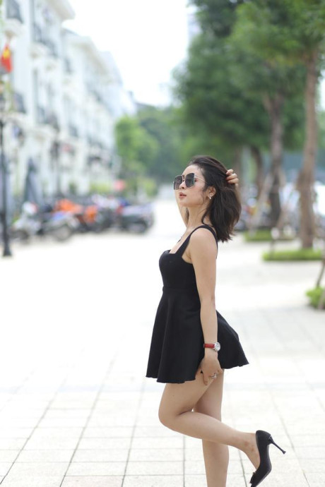 Chinese beauty Julia Nhatle posing in her little black dress & heels outdoors
