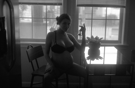 Pregnant woman masturbates with a vibrator in an erotic B&W scene