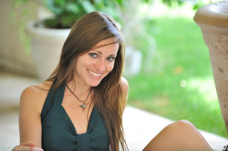 Attractive girl Amelia exposes her shaved clam and poses naked in a solo