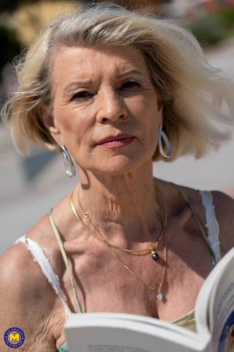 Yellow-haired granny Eva Delage exposes her lovely tasty melons and takes two cocks deeply