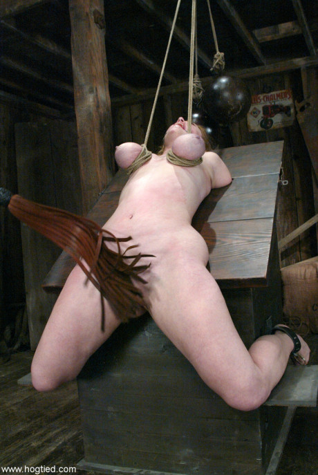 Hot submissive babe Dee Williams gets her gigantic boobs tied up on a BDSM table