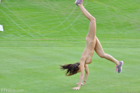 Fit girl lady strips off sports workout clothes to model naked on golf course