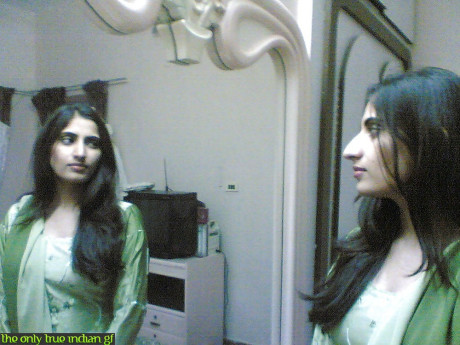 Indian girl girl woman takes selfies in a mirror while wearing a see-through tank top