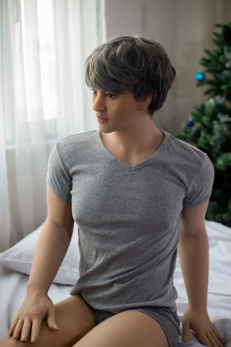 Fine male sex doll Penfield strokes his stiff schlong on the bed & shows his booty
