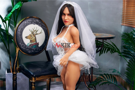 Chubby dark-haired sex doll shows off her curvy body in a sexy wedding dress