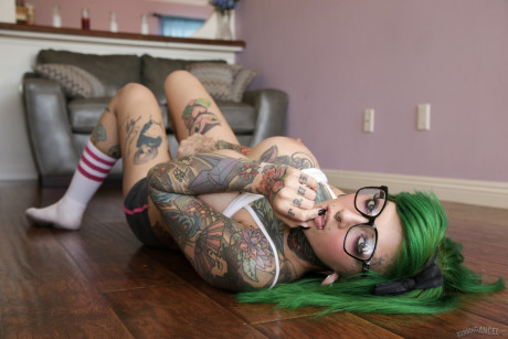 Green haired glasses wearing sweetie exposes massive melons & spreads snatch lips
