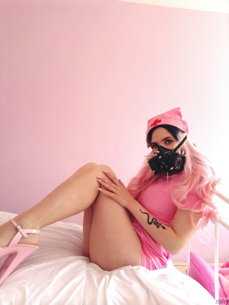 Wild Quarantine Challenge sheds her nurse costume & poses in a gas mask
