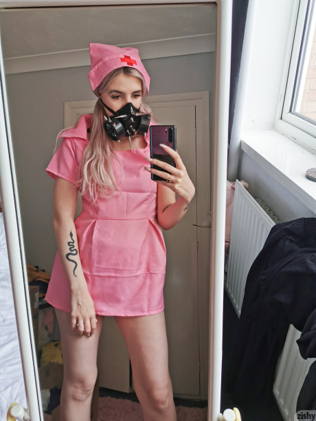 Wild Quarantine Challenge sheds her nurse costume & poses in a gas mask