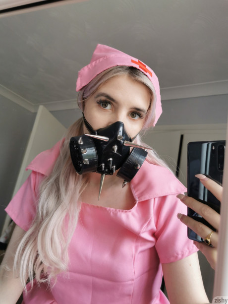 Wild Quarantine Challenge sheds her nurse costume & poses in a gas mask