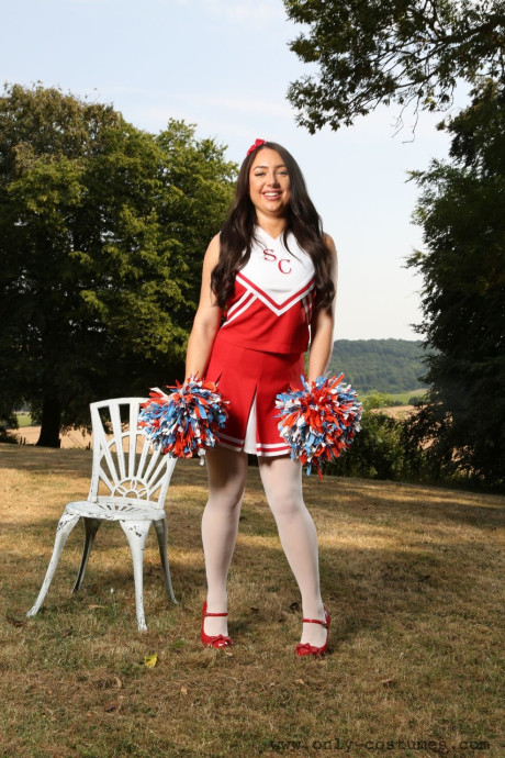 Smiley cheerleader Reanna strips to pantyhose while dancing outdoors