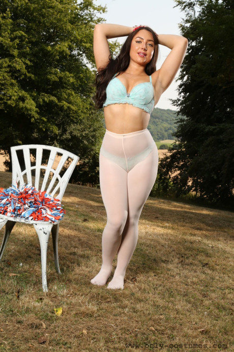 Smiley cheerleader Reanna strips to pantyhose while dancing outdoors