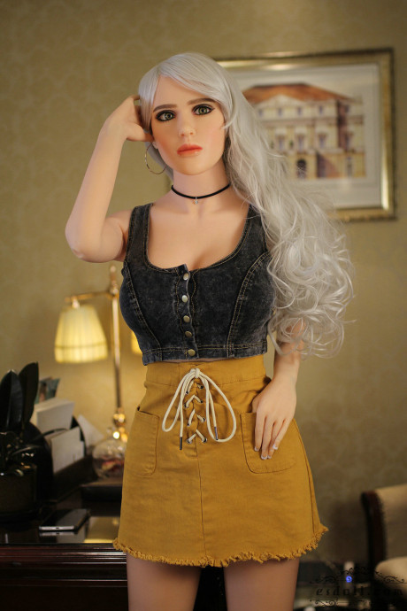 Realistic blonde sex doll shows off her big breasts while undressed