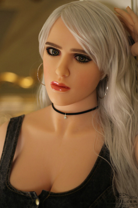 Realistic blonde sex doll shows off her big breasts while undressed