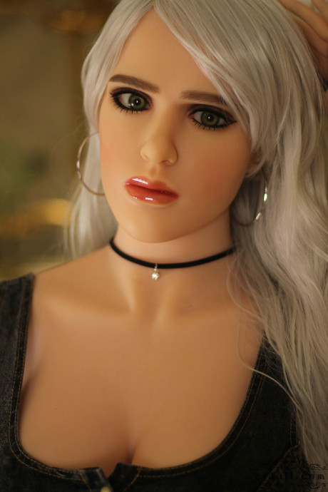 Realistic blonde sex doll shows off her big breasts while undressed