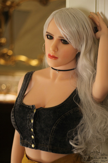 Realistic blonde sex doll shows off her big breasts while undressed