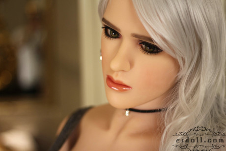 Realistic blonde sex doll shows off her big breasts while undressed