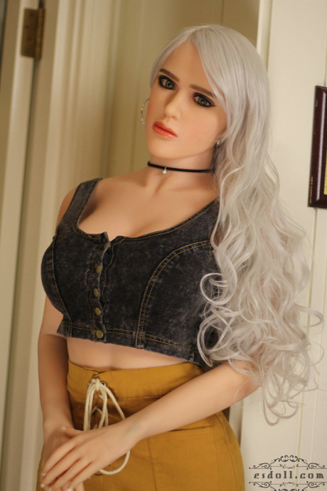 Realistic blonde sex doll shows off her big breasts while undressed
