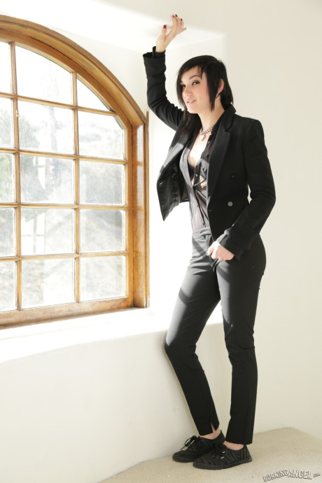 Pretty business lady Nikki Hearts takes off ebony suit and shows shaved cunt