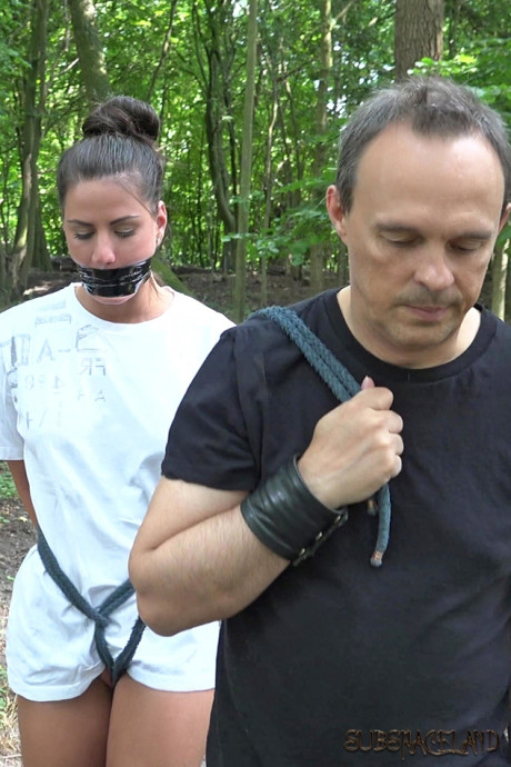 Young young brunette slave is disciplined and slammed in the forest by her Master
