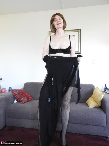 Redheaded granny Kat Kitty gets bare nude before inserting a sex toy