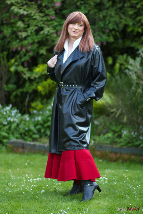 Juicy Luci May wore her fine lovely long rubber trench coat and a long red skirt