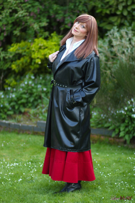Juicy Luci May wore her fine lovely long rubber trench coat and a long red skirt