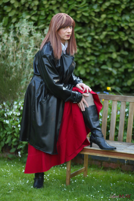 Juicy Luci May wore her fine lovely long rubber trench coat and a long red skirt
