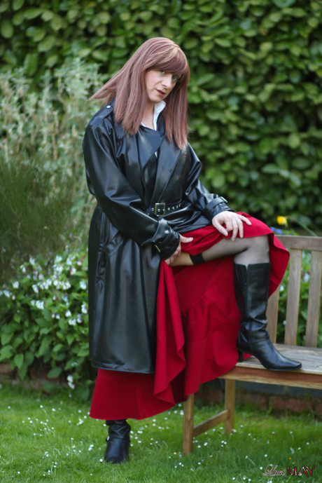 Juicy Luci May wore her fine lovely long rubber trench coat and a long red skirt