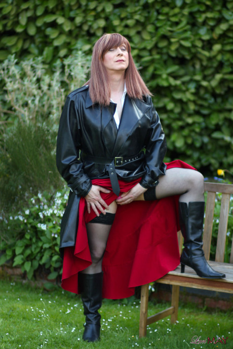Juicy Luci May wore her fine lovely long rubber trench coat and a long red skirt